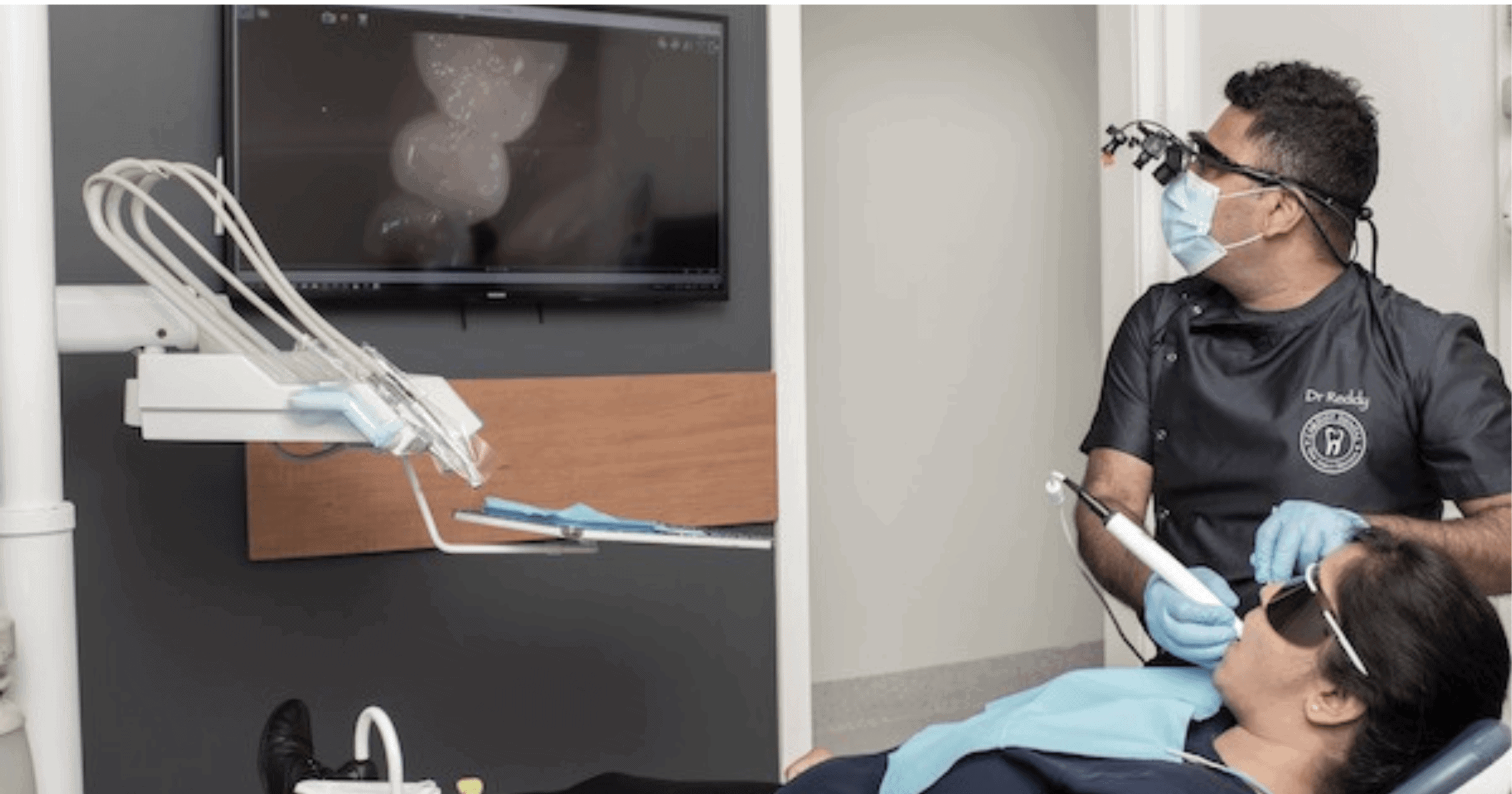 Cosmetic dentist in Newcastle examining a patient's smile at Cardiff Dental