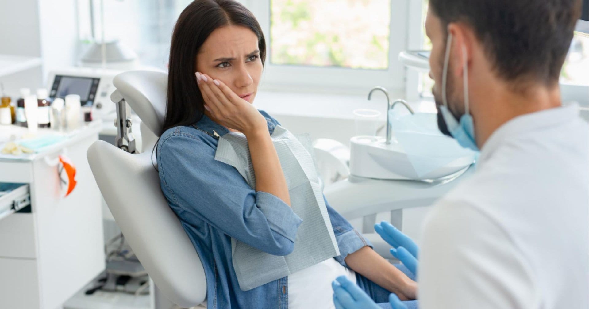 Dentist assessing the cause of tooth sensitivity in Newcastle
