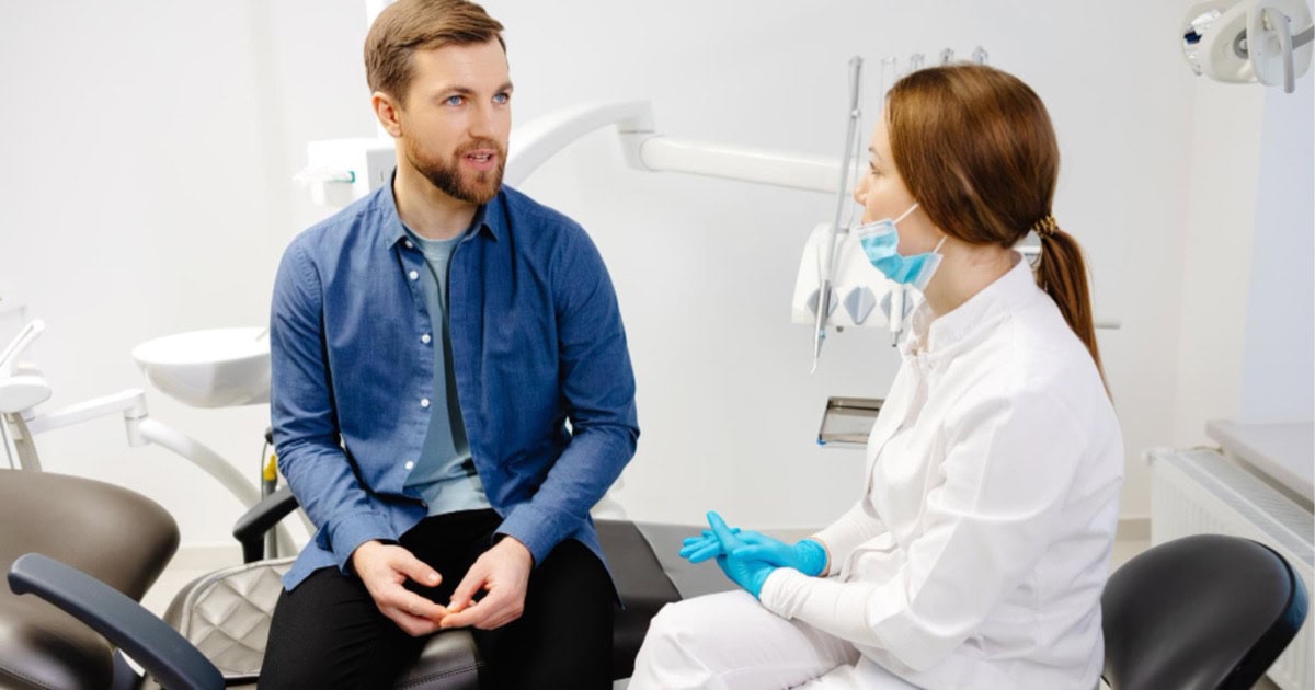 dentist consulting with a patient in Cardiff