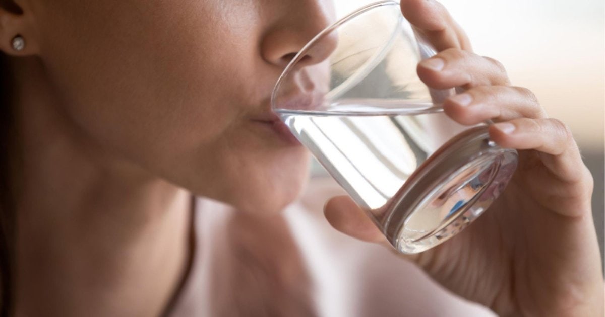 person drinking a glass of water in Cardiff